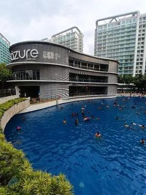 a large swimming pool in front of a building at Azure Urban Resort Staycation in Manila