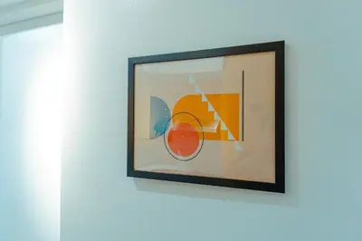 a picture hanging on a wall in a room at Consider It Yours - Stay Cozy with City Views in Manila