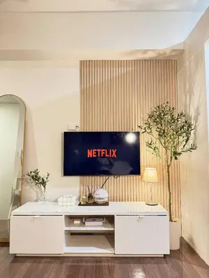 a living room with a television on a wall at Entire Room in Makati Center with FAST WIFI in Manila