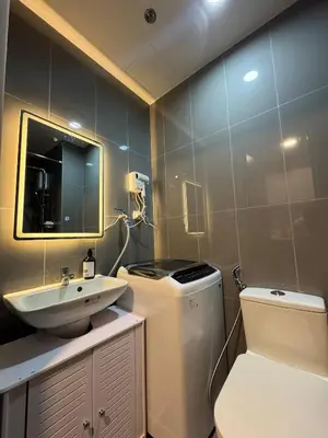 a bathroom with a sink and a toilet and a mirror at Entire Room in Makati Center with FAST WIFI in Manila