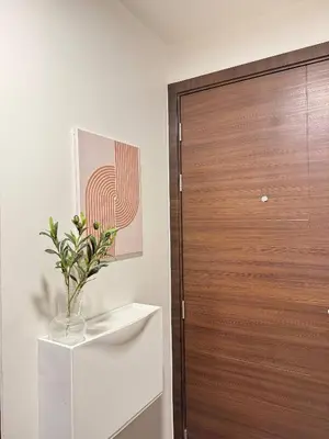 a room with a wooden door and a vase of flowers at Entire Room in Makati Center with FAST WIFI in Manila