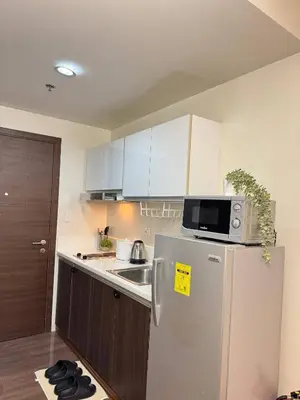 a kitchen with a refrigerator and a microwave at Entire Place in Central Makati in Manila