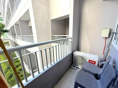 a balcony of a building with a chair and a heater at Instaworthy Space near BGC NAIA at Grace Res in Manila