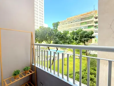 a balcony with a view of a park at Instaworthy Space near BGC NAIA at Grace Res in Manila