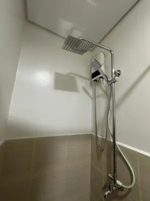 a shower in a bathroom with a shower head at Leaf Residences Muntinlupa - The Mint Pearl Stay 2 bedroom in Manila