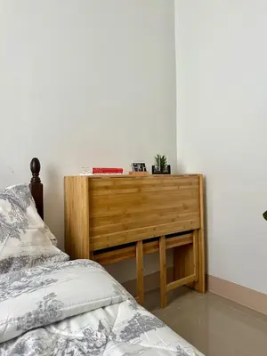 a bedroom with a bed and a wooden dresser at Leaf Residences Muntinlupa - The Mint Pearl Stay 2 bedroom in Manila