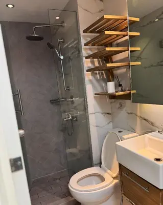 a bathroom with a shower and a toilet and a sink at Modern Condo with Premium Beach View at Azure Urban Resort Residences - Vesta Property in Manila