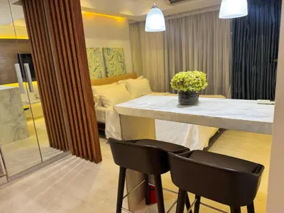 a dining room with a table and two chairs at Modern Condo with Premium Beach View at Azure Urban Resort Residences - Vesta Property in Manila