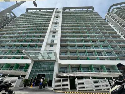 a large white building with green windows at Modern Condo with Premium Beach View at Azure Urban Resort Residences - Vesta Property in Manila