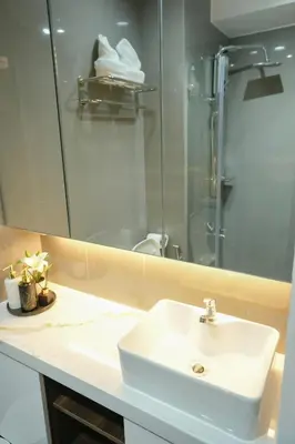 a bathroom with a white sink and a shower at Hotel Like Staycation 3 Makati with Amazing View in Manila