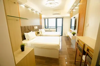 a hotel room with two beds and a bathroom at Hotel Like Staycation 3 Makati with Amazing View in Manila