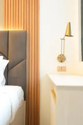 a bedroom with a bed and a desk with a lamp at Hotel Like Staycation 3 Makati with Amazing View in Manila