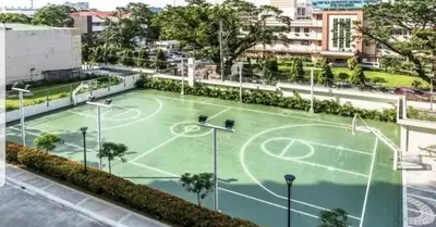 a tennis court in the middle of a city at La verti 1BR Affordable staycation for family groups in Manila
