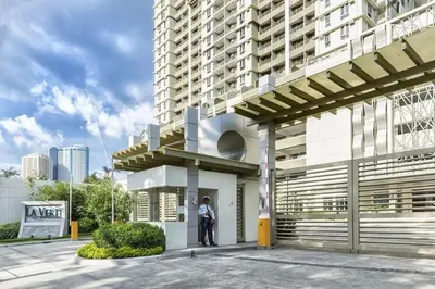 a man standing in front of a building at La verti 1BR Affordable staycation for family groups in Manila