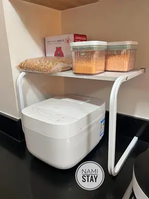 a kitchen counter with a food processor on a shelf at Nami Stay at Shore Residences 1 in Manila