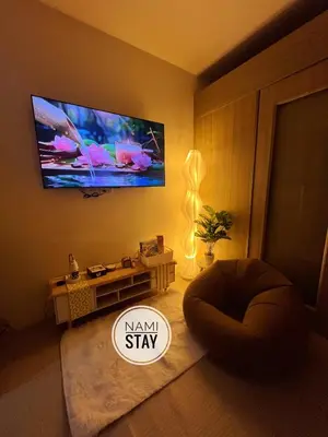 a living room with a flat screen tv on the wall at Nami Stay at Shore Residences 1 in Manila