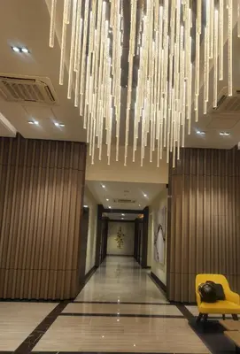 a hallway with a large chandelier in a hotel at BGC Family Suite Steps Away from Mall with FREE Parking with Washer Dryer in Manila