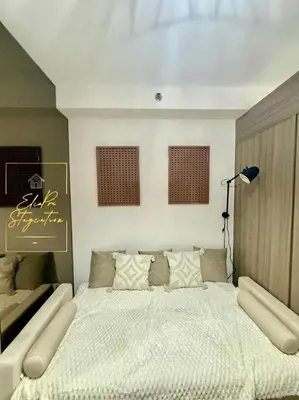 a bedroom with a large white bed in it at ElcaPri Staycation Unit 2 - Shore 2 in Manila