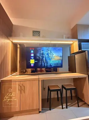 a desk with a television on top of it at ElcaPri Staycation Unit 2 - Shore 2 in Manila