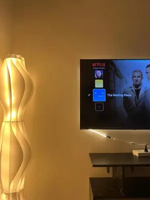 a living room with a tv and a lamp at Cozy Minimalist Condo unit in Manila