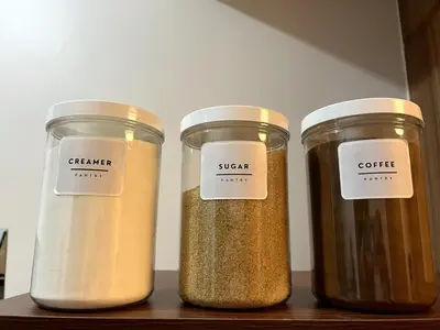 three jars of spices sitting on a wooden shelf at Cozy Minimalist Condo unit in Manila