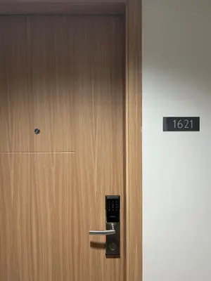 a wooden door with a clock on it at Cozy Minimalist Condo unit in Manila
