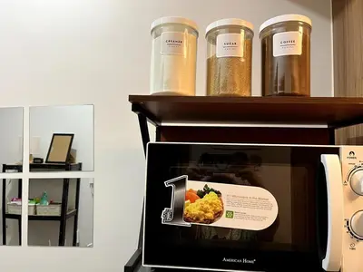 a microwave with a picture of food in it at Cozy Minimalist Condo unit in Manila