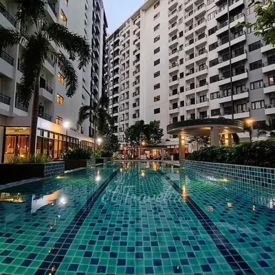 a large swimming pool in front of some buildings at Staycation 15 minutes from NAIA with Massage Chair in Manila