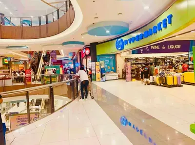 a person pushing a cart in a shopping mall at Staycation 15 minutes from NAIA with Massage Chair in Manila
