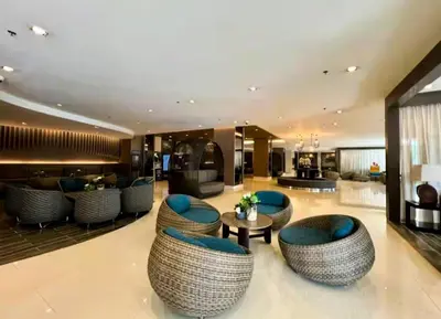 a hotel lobby with blue chairs and a table at SLY Staycation at Shore Residences Mall of Asia in Manila