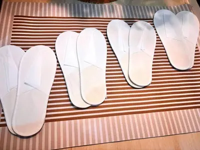 three pairs of white flip flops sitting on a table at SLY Staycation at Shore Residences Mall of Asia in Manila