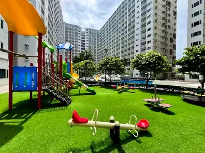 a park with a playground with slides and play equipment at SLY Staycation at Shore Residences Mall of Asia in Manila