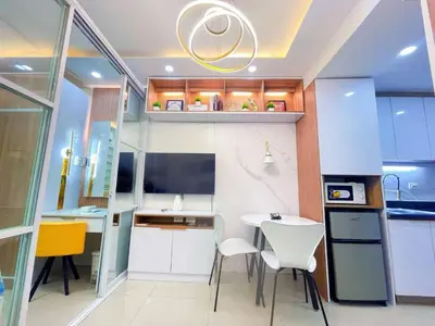 a small kitchen with a white table and chairs at shore 2 tower 3 near moa in Manila