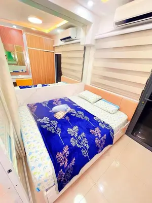 a bed in the middle of a room at shore 2 tower 3 near moa in Manila