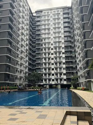 a swimming pool in front of two tall buildings at Jays BnB in Manila
