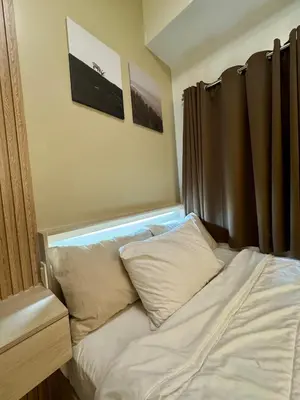 a bed with white sheets and pillows in a room at Jays BnB in Manila