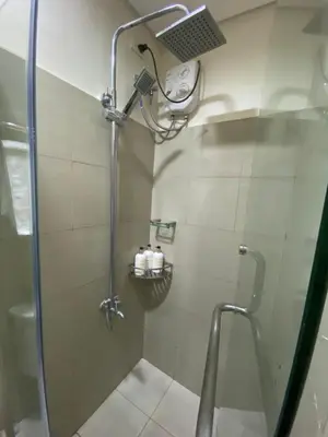 a shower with a shower head in a bathroom at MGS Suite Shore 2 Residences in Manila
