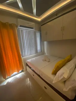 a small room with a bed and a window at MGS Suite Shore 2 Residences in Manila