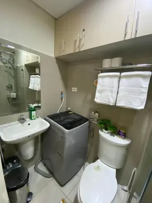 a small bathroom with a toilet and a sink at MGS Suite Shore 2 Residences in Manila