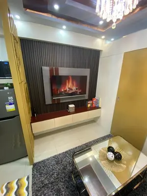 a living room with a fire in the fireplace at MGS Suite Shore 2 Residences in Manila