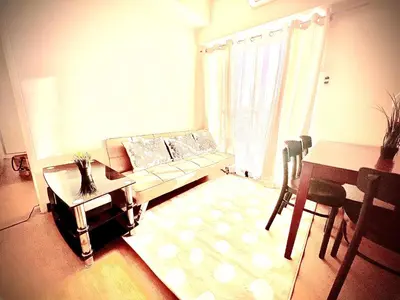 a living room with a couch and a table at Angel's Place Torre De Manila, Cozy 1BR Condo, Sunset View Near all Attractions in Manila