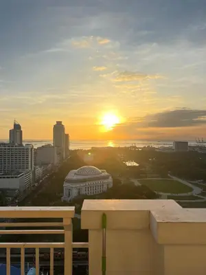 a view of a city with the sunset in the background at Angel's Place Torre De Manila, Cozy 1BR Condo, Sunset View Near all Attractions in Manila
