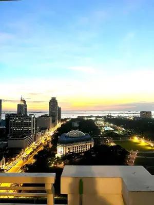 a view of a city skyline at night at Angel's Place Torre De Manila, Cozy 1BR Condo, Sunset View Near all Attractions in Manila