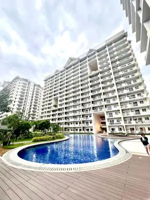 a large apartment building with a large swimming pool at Angels Place The Atherton, Manila Condo Near Airport in Manila