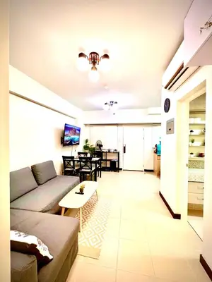 a living room with a couch and a table at Angels Place The Atherton, Manila Condo Near Airport in Manila