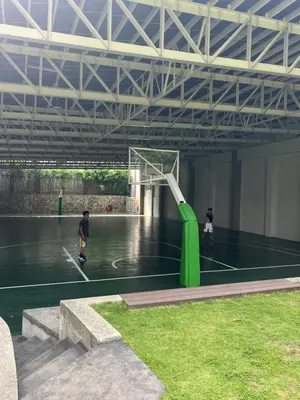 two people are playing basketball on a basketball court at Angels Place The Atherton, Manila Condo Near Airport in Manila