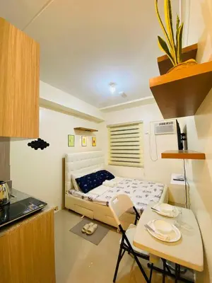 a small room with a bed and a table and a tableablish at Fully Furnished Studio Type Room for Rent Can be long term or short term in Manila