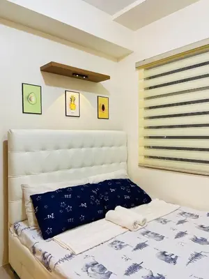 a bedroom with a bed with a blue and white blanket at Fully Furnished Studio Type Room for Rent Can be long term or short term in Manila