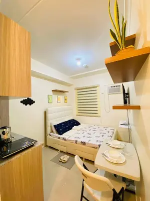 a bedroom with a bed and a table and chairs at Fully Furnished Studio Type Room for Rent Can be long term or short term in Manila