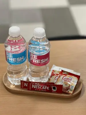 two bottles of water and a snack on a tray at Studio Condo by Sea Residences near MOA 02 in Manila